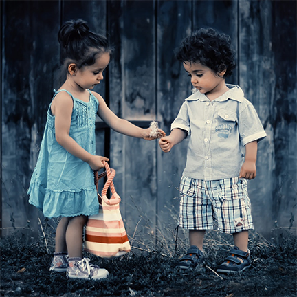 Photo of two children sharing flowers